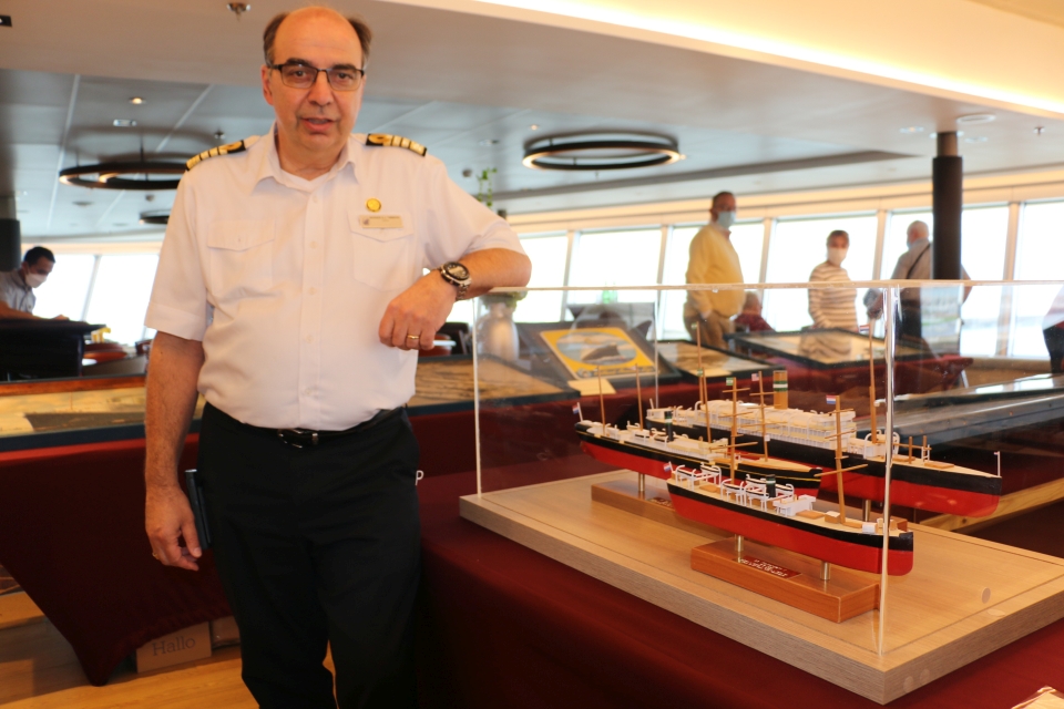 Holland America Line Captain Werner Timmers of the Rotterdam VII with the models he built of the Rotterdam I, II and III (photo: Riekelt Pasterkamp).