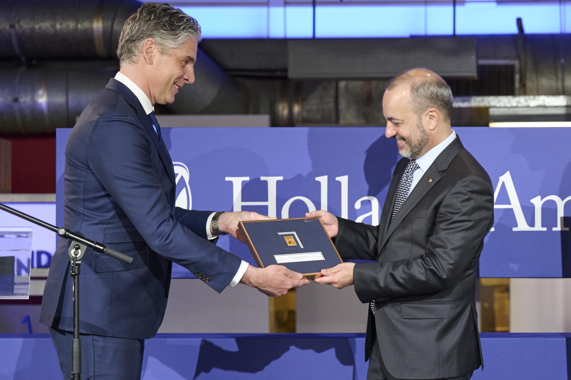 [pic] Holland America Line worked closely with PostNL to design a gold stamp in honour of the 150th anniversary. This stamp was handed over by Bob van Ierland, Managing Director PostNL Netherlands, to Gus Antorcha, President of Holland America` Line, during the ceremony (picture by Rebekah Mell).